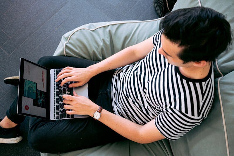 Image of a developer writing ideas on a whiteboard next to a laptop